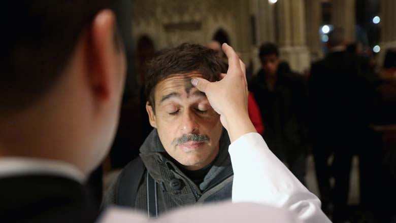 NEW YORK, NY - FEBRUARY 13: A man receives a cross of black ashes on his forehead on Ash Wednesday at St. Patrick's Cathedral on February 13, 2013 in New York City. Ash Wednesday marks the beginning of Lent, a 40-day period of pray and fasting for many Christians. (Photo by John Moore/Getty Images)