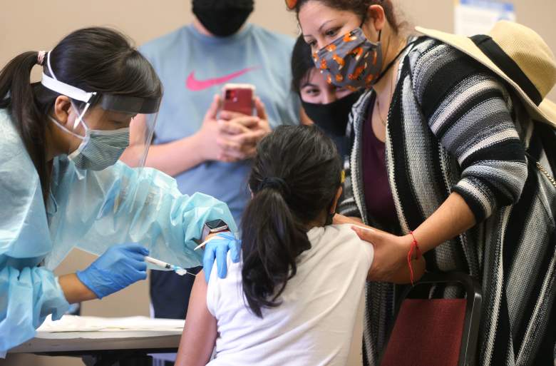 Una niña recibe la vacuna contra la influenza de una enfermera en una clínica gratuita celebrada en una biblioteca local el 14 de octubre de 2020 en Lakewood, California.
