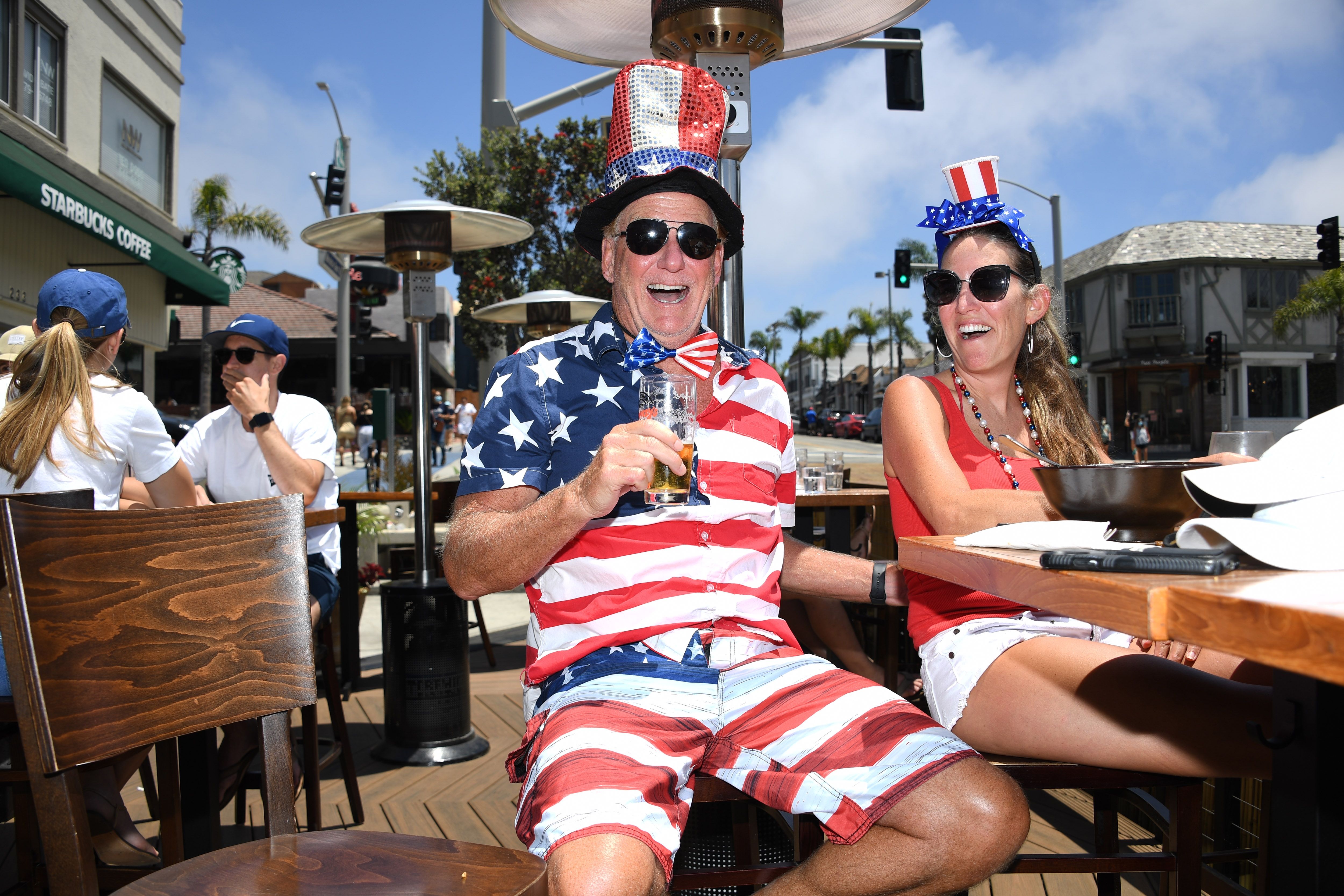 Dave Barnes disfruta de un almuerzo navideño con su esposa Christy Barnes en un restaurante al aire libre en Manhattan Beach, California, donde las playas están cerradas debido a un pico de COVID-19 en el condado de Los Ángeles, el 4 de julio de 2020, el feriado del Día de la Independencia de EE. UU.