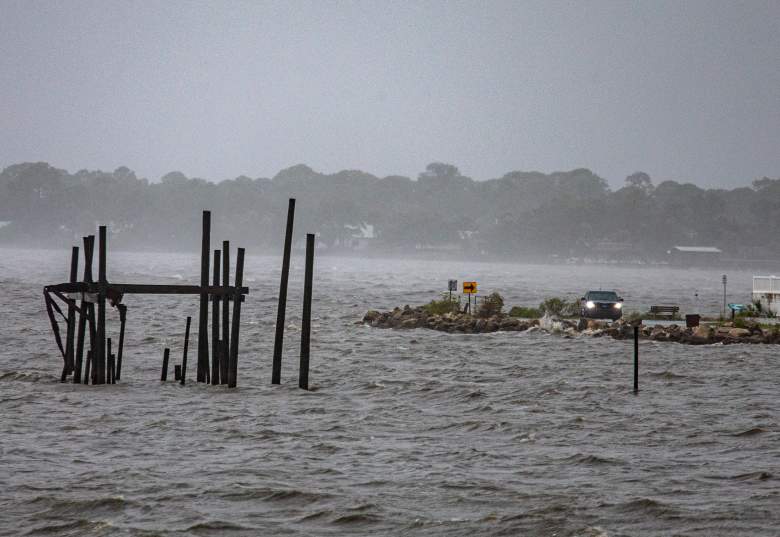 Un automóvil conduce a lo largo de la costa mientras la tormenta tropical Elsa toca tierra el 7 de julio de 2021 en Cedar Key, Florida.