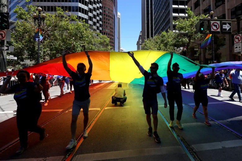 Los manifestantes llevan una bandera del Orgullo de gran tamaño durante el 52º Desfile y Celebración Anual del Orgullo de San Francisco el 26 de junio de 2022 en San Francisco, California. Miles de personas asistieron al desfile anual del Orgullo de SF después de una pausa de dos años debido a la pandemia de COVID-19.