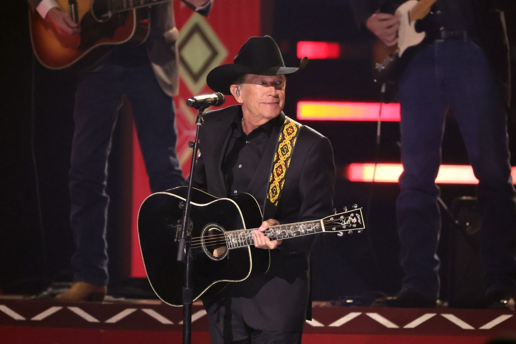George Strait holding a guitar