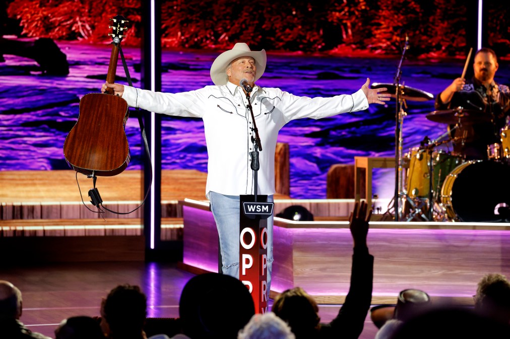 Alan Jackson holding a guitar on stage